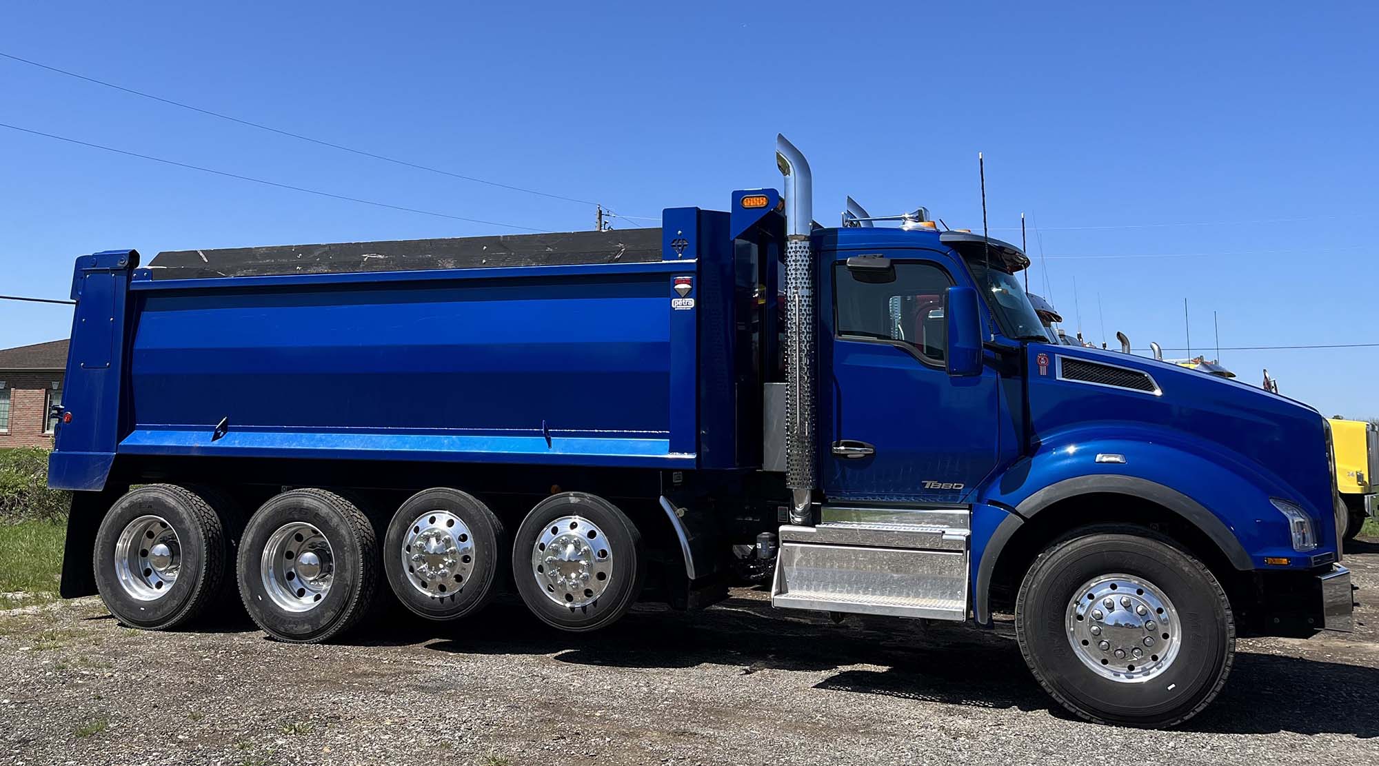 Side view of a blue Kenworth dump truck