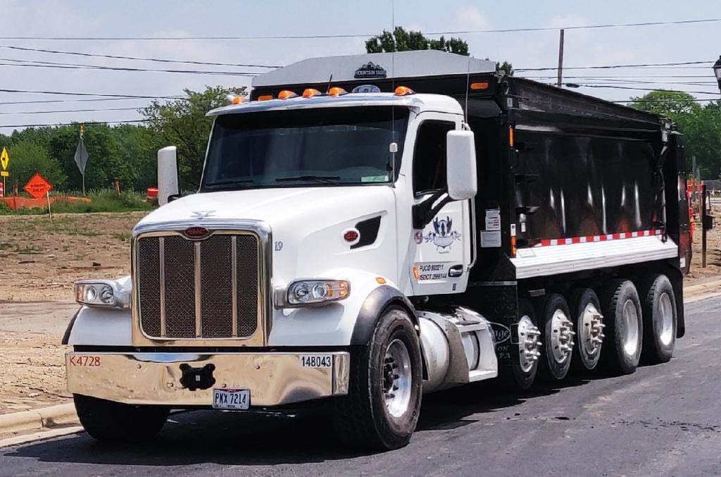 side of hauling truckm black trailer